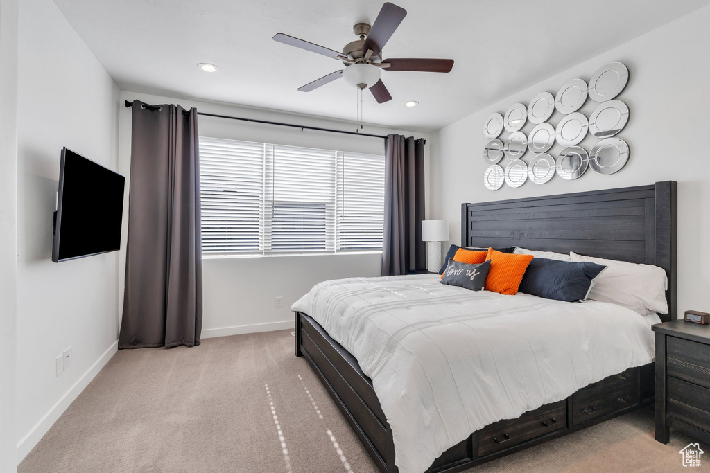 Carpeted bedroom featuring baseboards, recessed lighting, and a ceiling fan