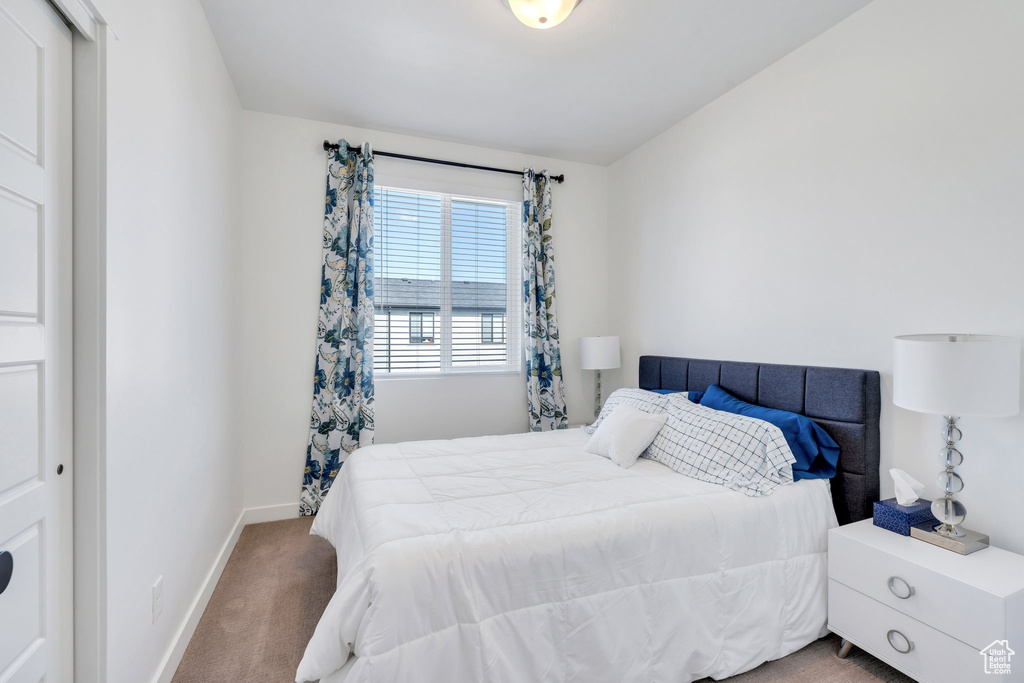 Carpeted bedroom with baseboards