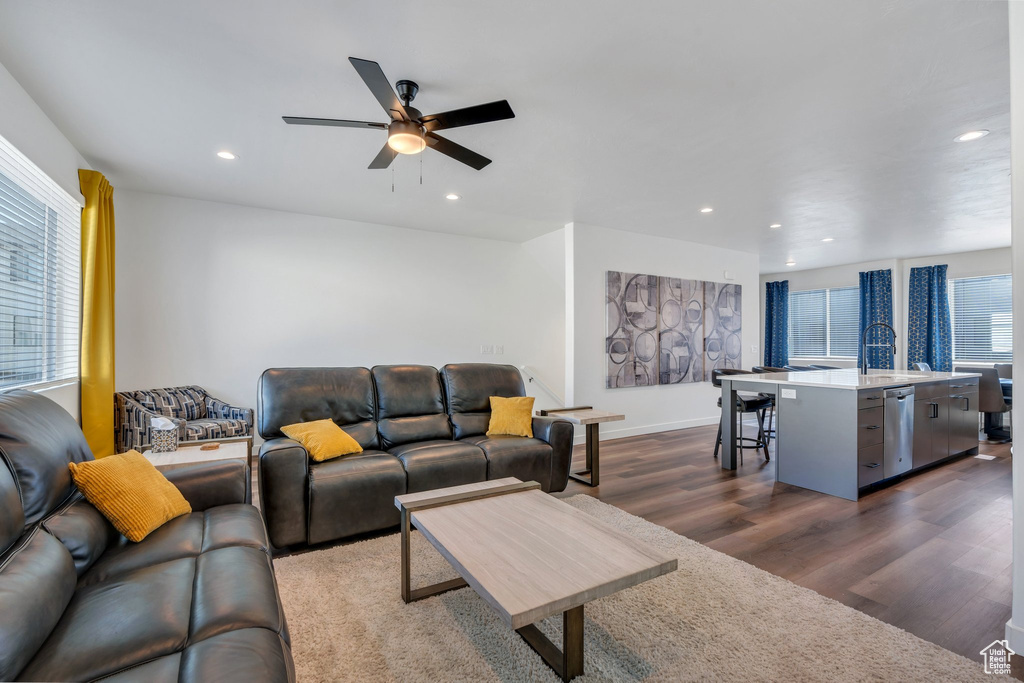 Living area with dark wood finished floors, ceiling fan, recessed lighting, and baseboards