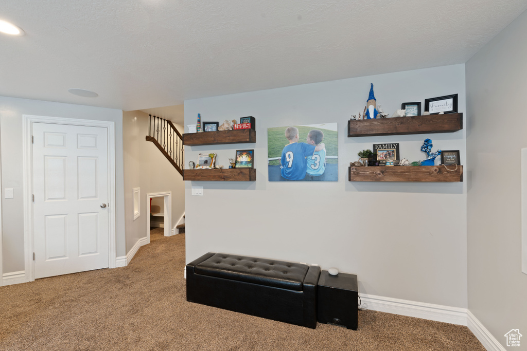 Hall with carpet floors, stairway, and baseboards