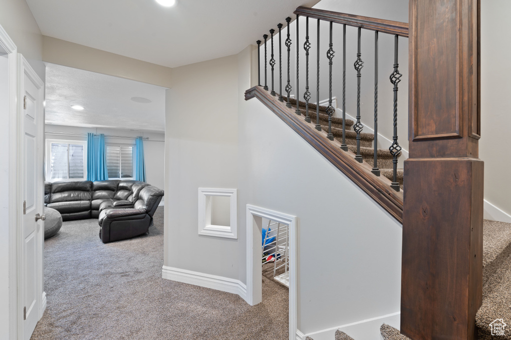 Staircase with carpet flooring, baseboards, and recessed lighting