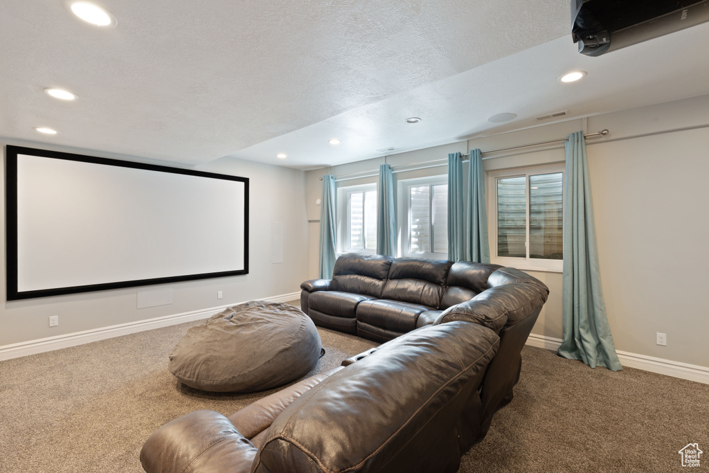 Cinema room featuring recessed lighting, carpet flooring, baseboards, and a textured ceiling