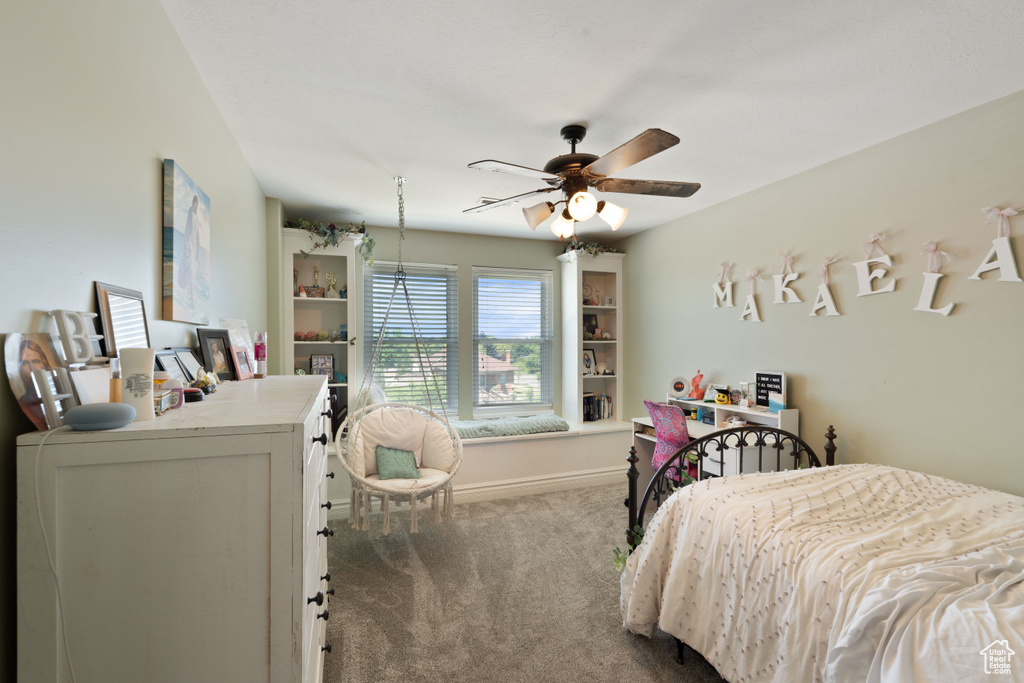 Bedroom with carpet flooring, ceiling fan, and baseboards