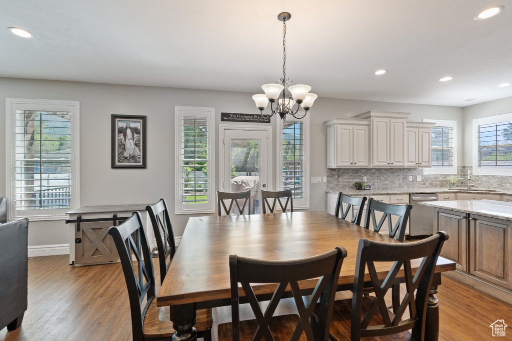 Dining area with a chandelier, recessed lighting, light wood finished floors, and baseboards