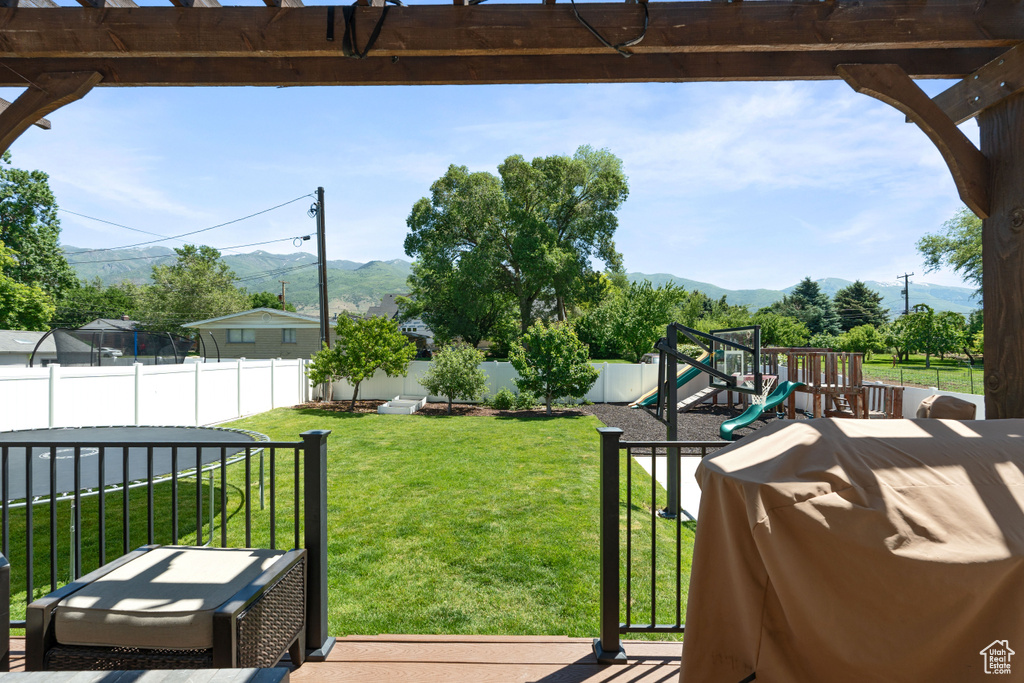 View of yard featuring a mountain view and a playground