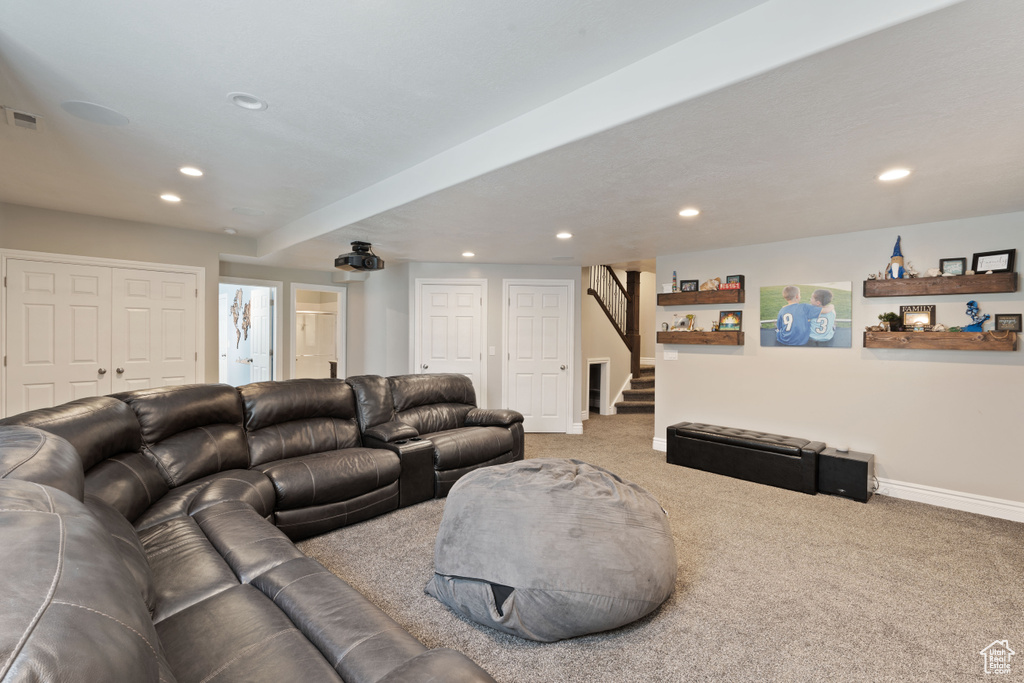 Living room featuring carpet, recessed lighting, baseboards, and stairway