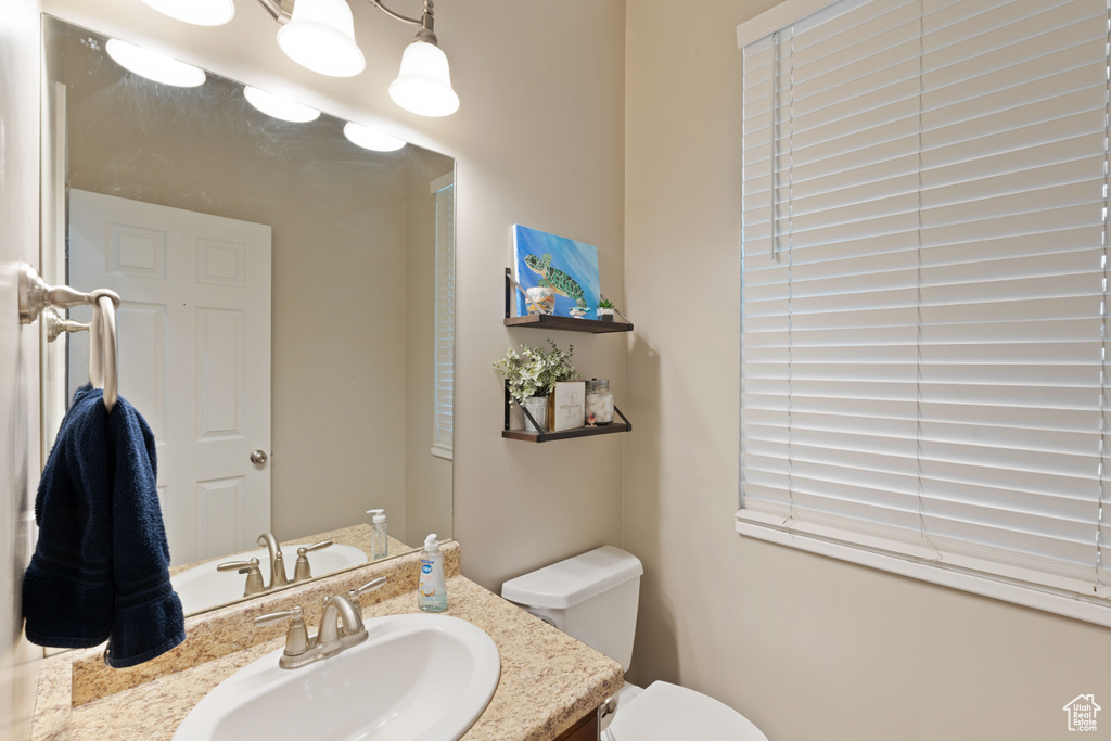 Half bathroom with toilet and vanity