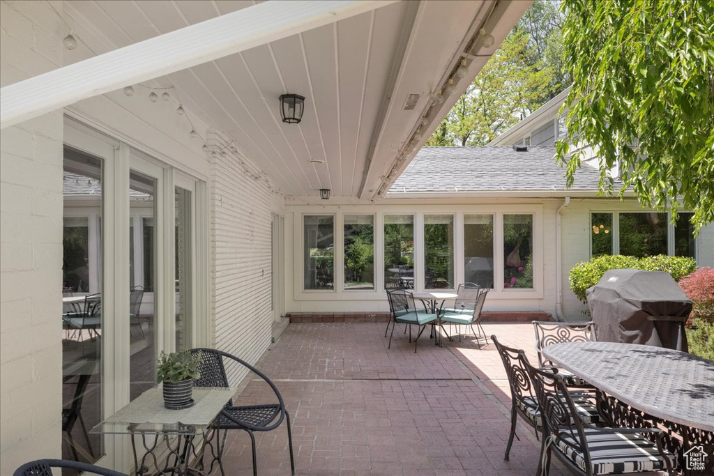 View of patio featuring outdoor dining area and a grill