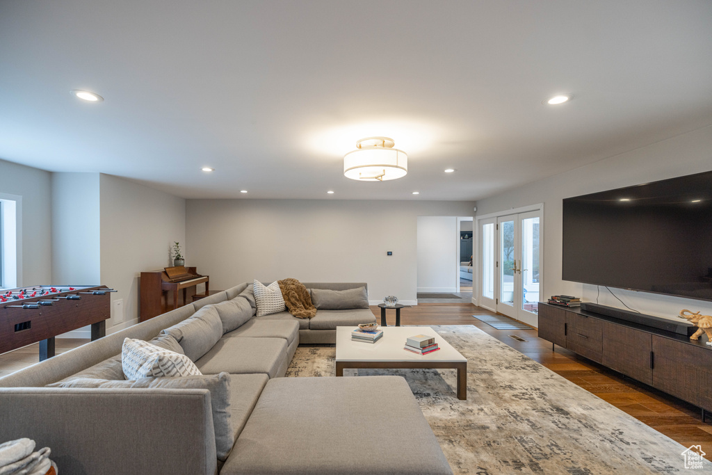 Living room with french doors and dark wood-type flooring