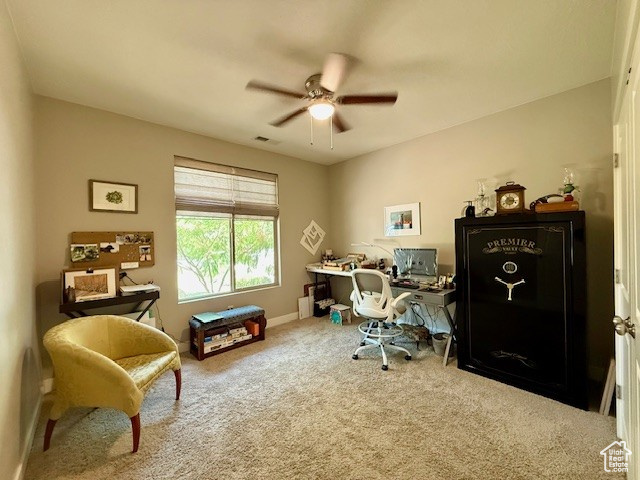 Carpeted office featuring a ceiling fan and baseboards