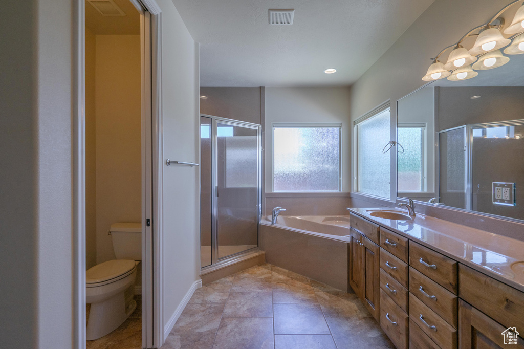 Full bath with a stall shower, a bath, toilet, and vanity