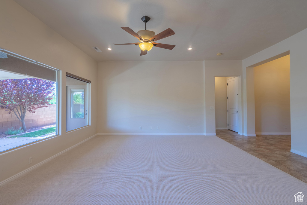 Spare room with recessed lighting, ceiling fan, baseboards, and light carpet