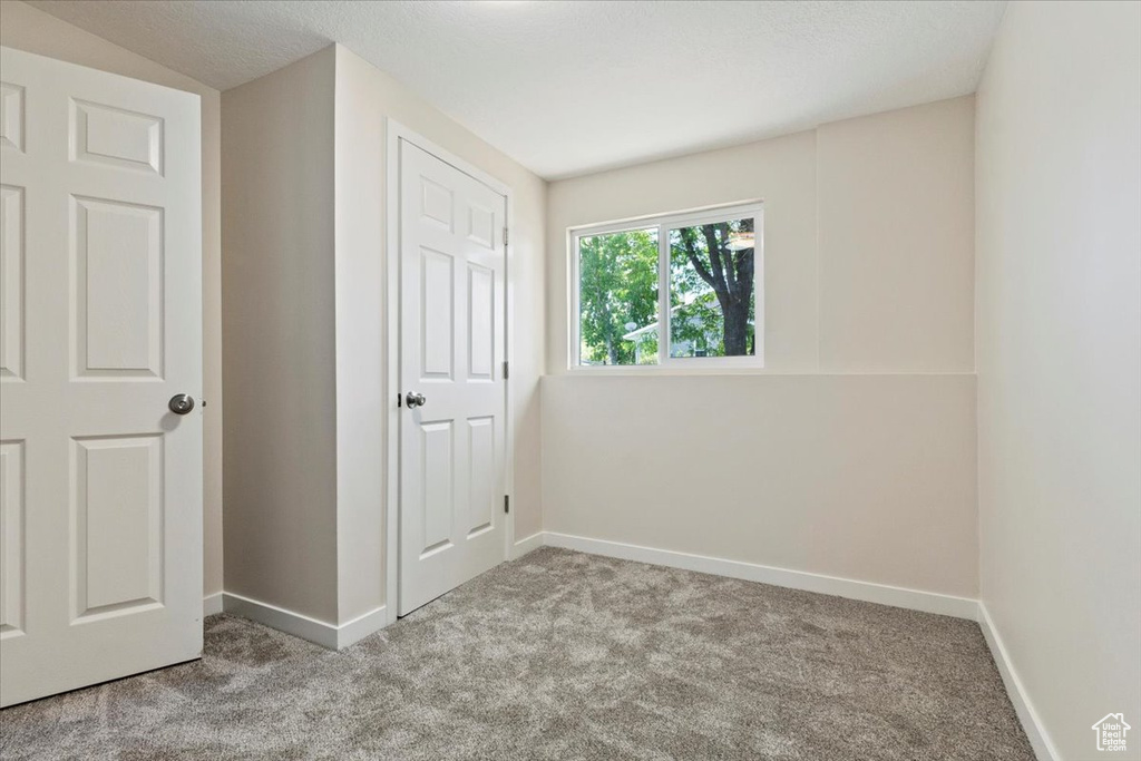 Unfurnished bedroom featuring carpet floors and baseboards