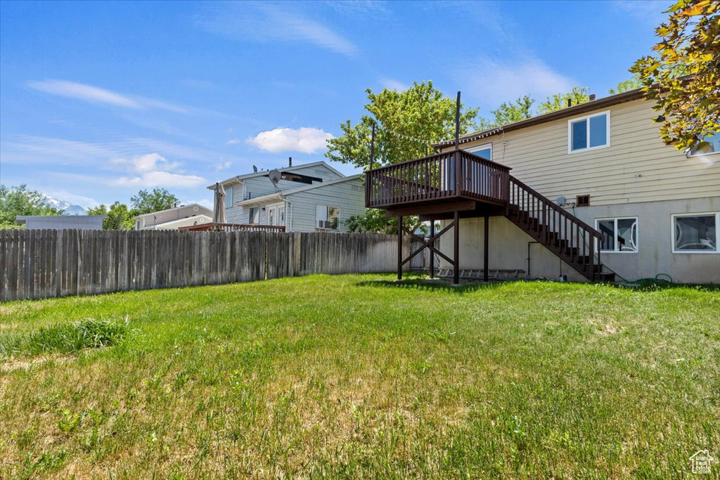 View of yard with stairway and a deck