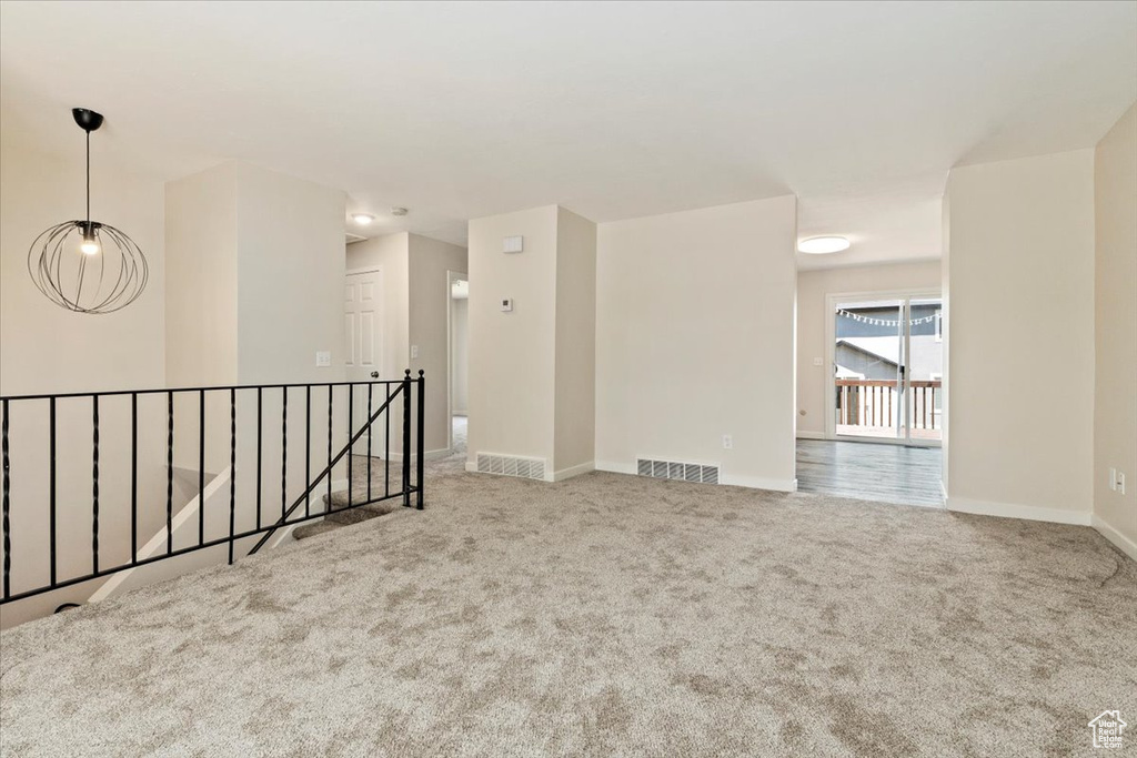 Empty room featuring carpet floors and baseboards