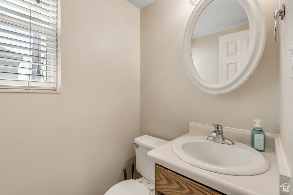 Half bath featuring vanity and toilet