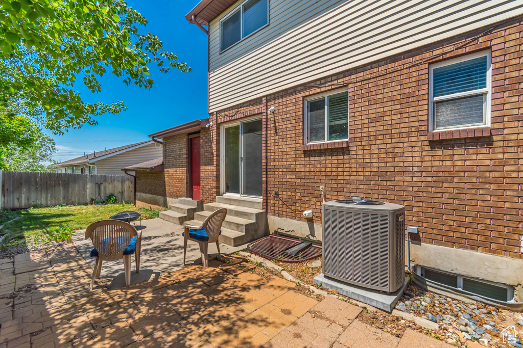 View of patio with entry steps and cooling unit