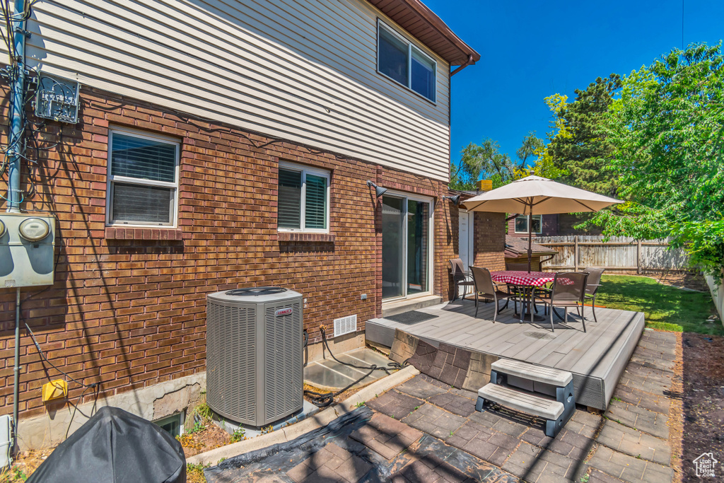 View of patio featuring central air condition unit and outdoor dining space