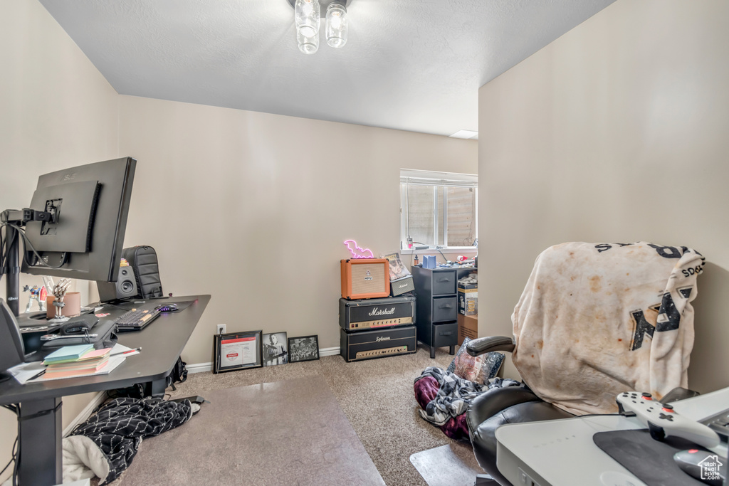 Carpeted home office featuring baseboards