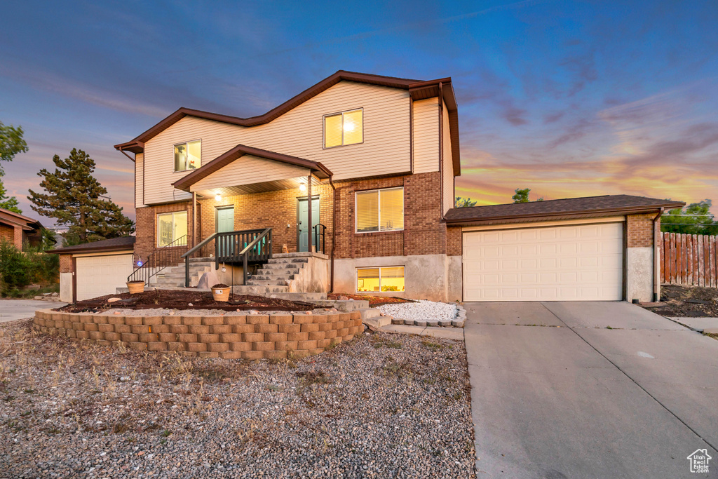 View of front of house with brick siding and concrete driveway