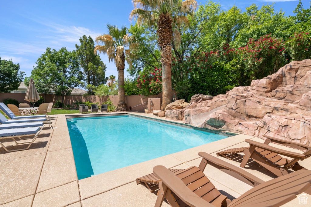 View of pool with a patio area and a fenced backyard