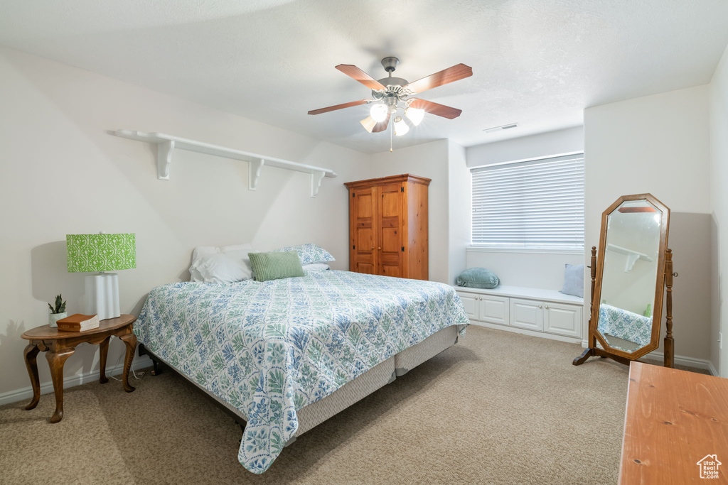 Bedroom featuring light carpet and ceiling fan