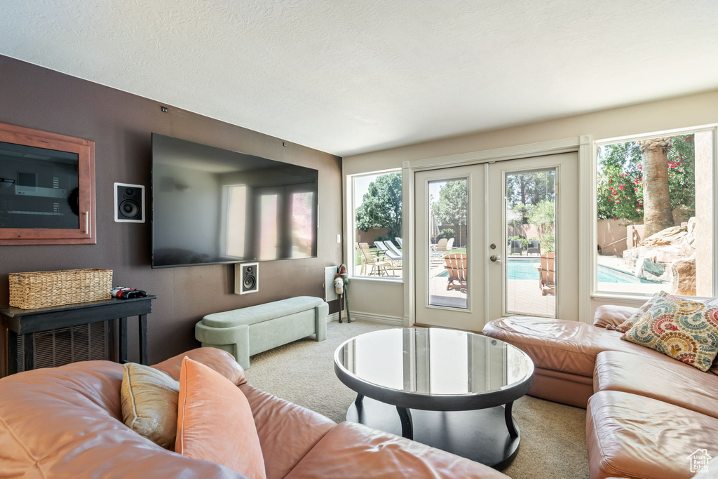 Living area featuring carpet and french doors