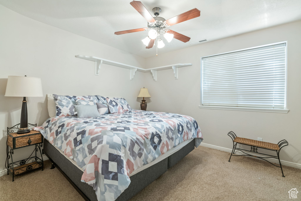 Bedroom with carpet flooring and a ceiling fan