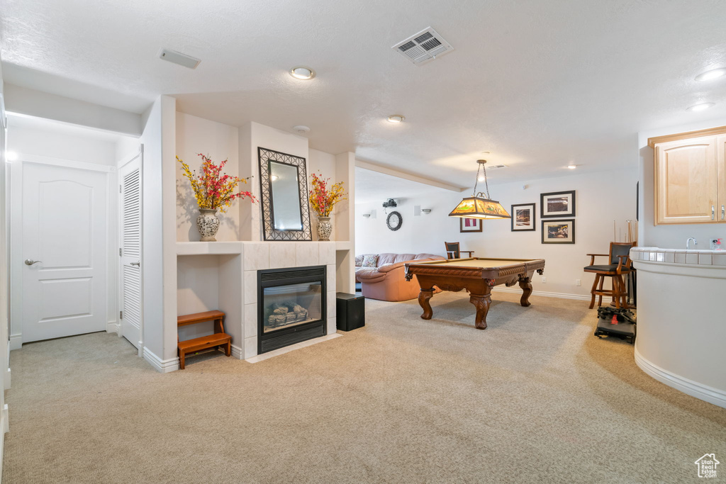 Recreation room featuring carpet floors, billiards table, a tile fireplace, and recessed lighting