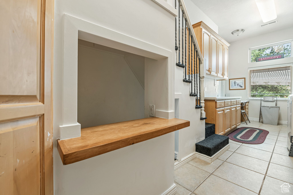 Mudroom with light tile patterned floors and baseboards