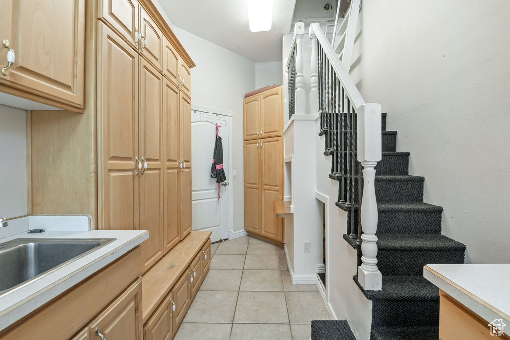 Washroom featuring light tile patterned floors and a sink