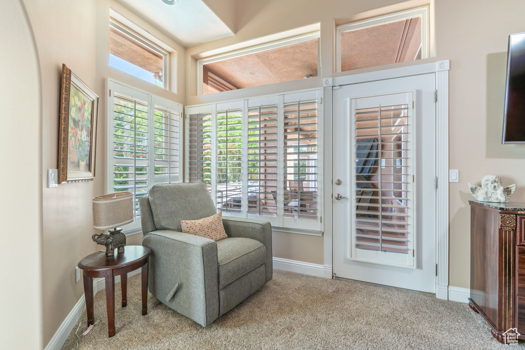 Sitting room featuring carpet floors and baseboards