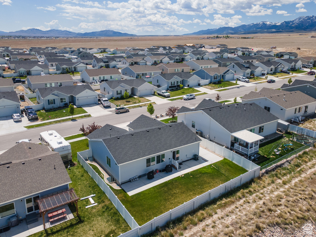 Aerial perspective of suburban area featuring a mountainous background
