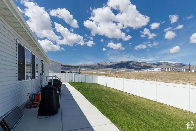 View of yard featuring a mountain view and a patio