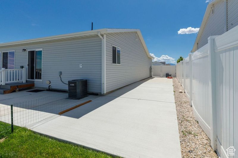 View of home's exterior featuring central AC, a patio, and a fenced backyard
