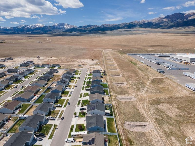 View of property location featuring mountains, nearby suburban area, and rural landscape
