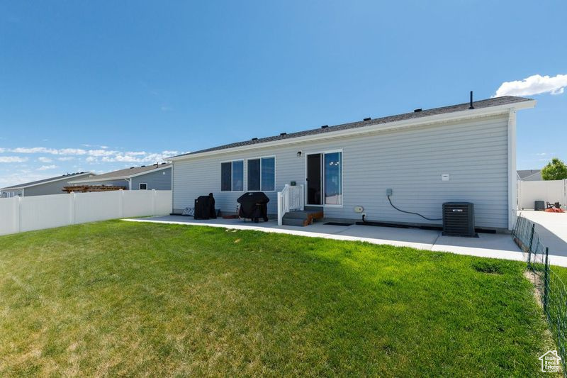 Rear view of house with a patio, cooling unit, and entry steps