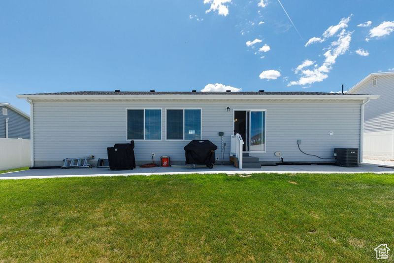 Rear view of property featuring a patio, central air condition unit, and entry steps