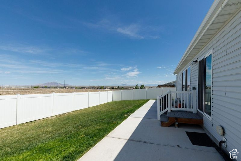 View of yard with a patio and a mountain view