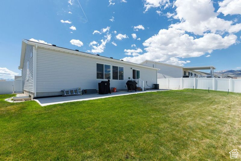 Rear view of property featuring a patio area
