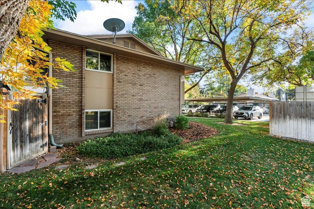 View of property exterior with brick siding