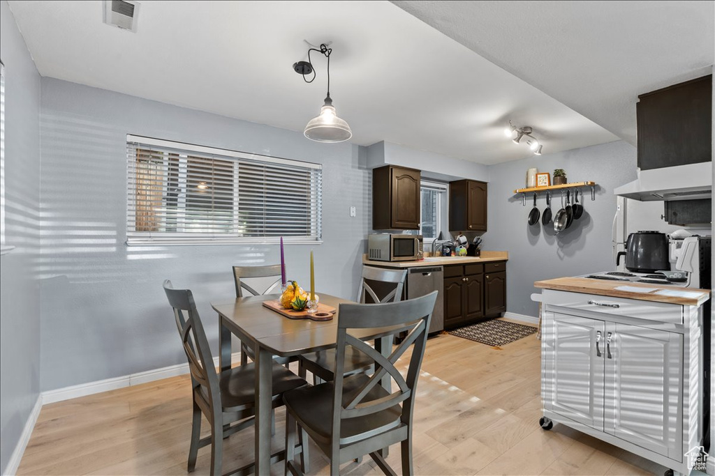 Dining room featuring baseboards and light wood-type flooring