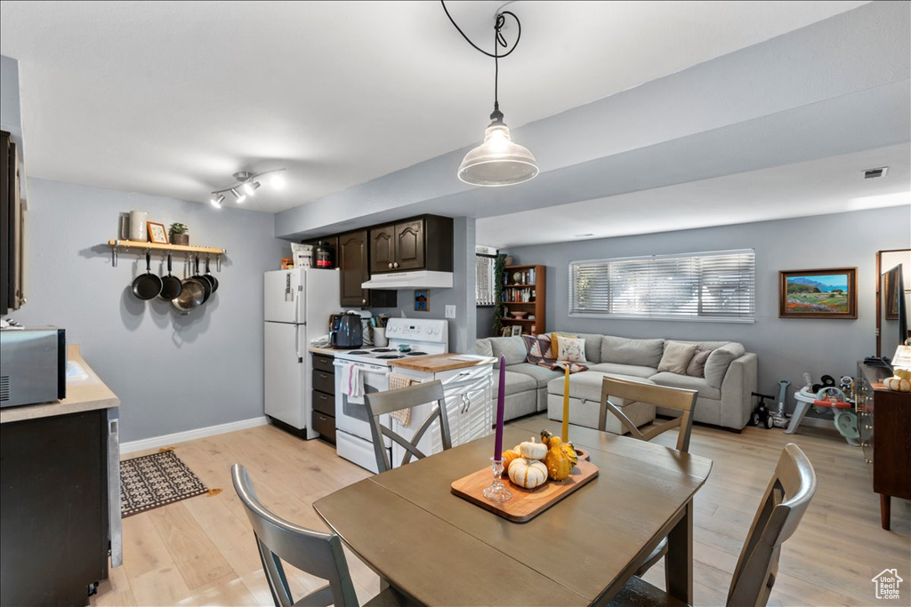 Dining space featuring light wood-type flooring and baseboards