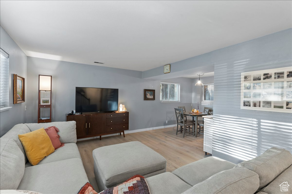 Living area featuring light wood-style flooring and baseboards
