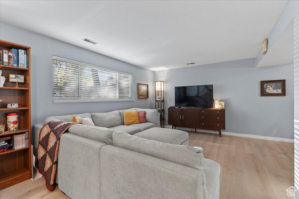 Living area featuring light wood-style floors and baseboards