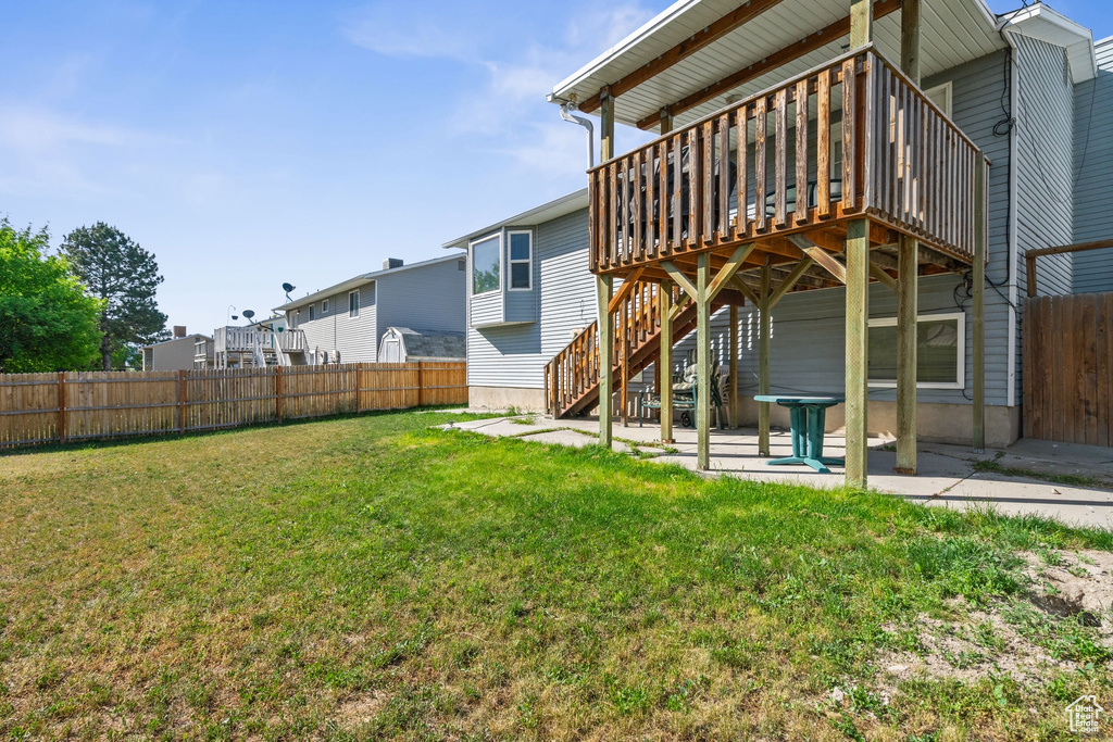 Rear view of house featuring a deck, a patio, and stairway