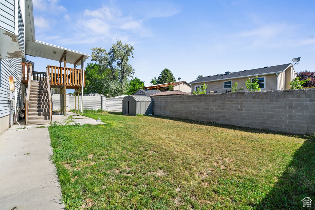 View of yard with stairs and a deck