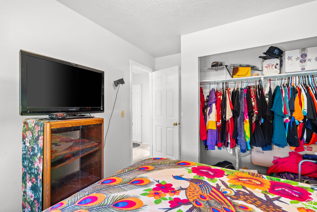 Bedroom with a closet and a textured ceiling
