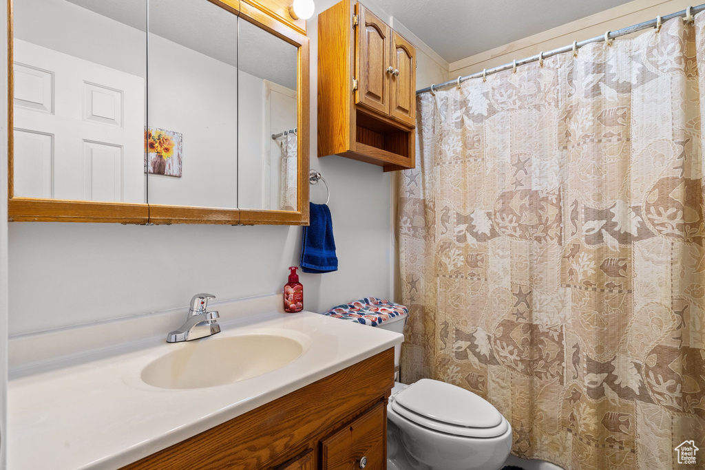 Full bathroom with vanity and toilet
