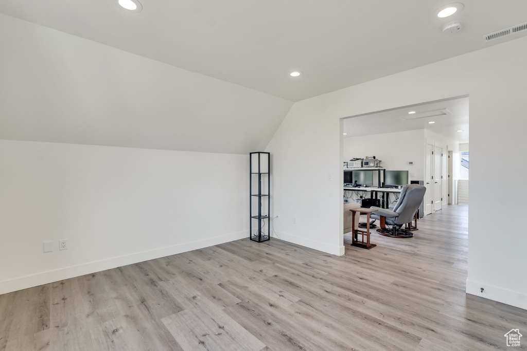 Additional living space with recessed lighting, wood finished floors, baseboards, and lofted ceiling